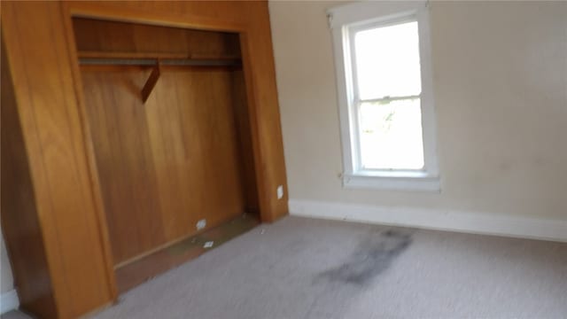 bedroom with a closet and light colored carpet