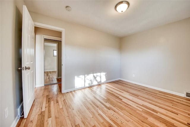 spare room with light wood-type flooring