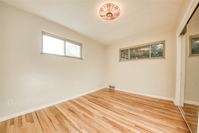 unfurnished room featuring light hardwood / wood-style floors and a healthy amount of sunlight