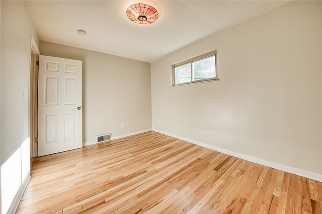 empty room with light hardwood / wood-style flooring