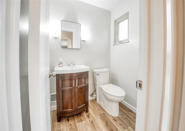 bathroom featuring vanity, toilet, and wood-type flooring