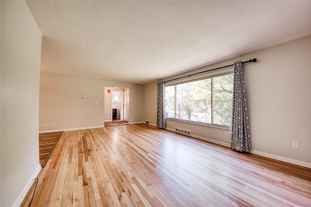 empty room with light hardwood / wood-style floors