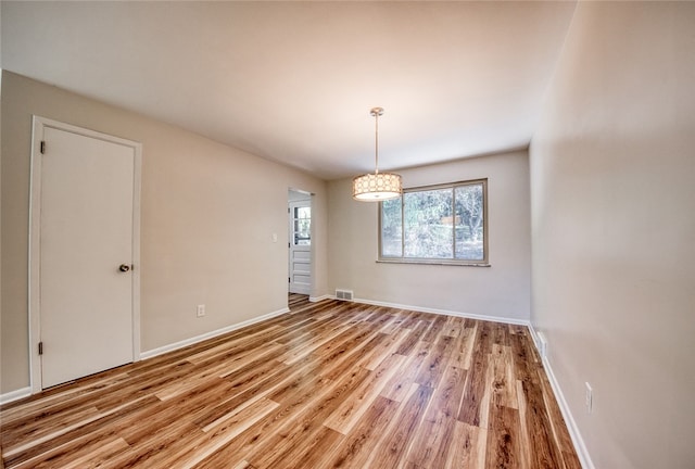 unfurnished room featuring hardwood / wood-style floors