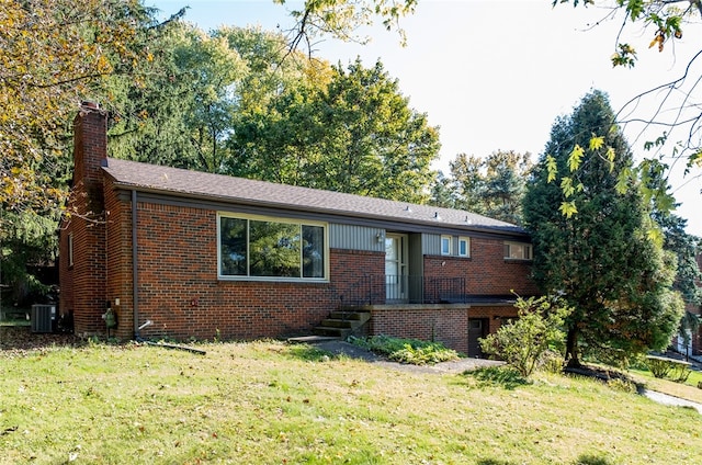 view of front of property featuring central AC and a front yard