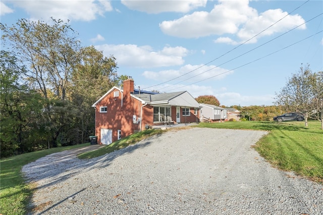 view of front of house with a porch, a front yard, and a garage