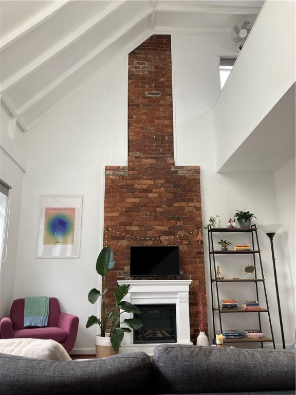 living room with a healthy amount of sunlight and high vaulted ceiling