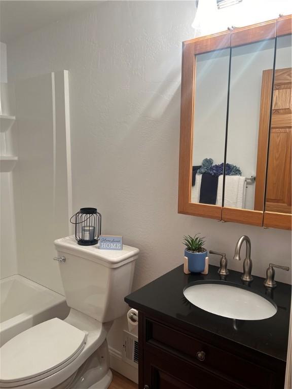 bathroom with vanity and toilet