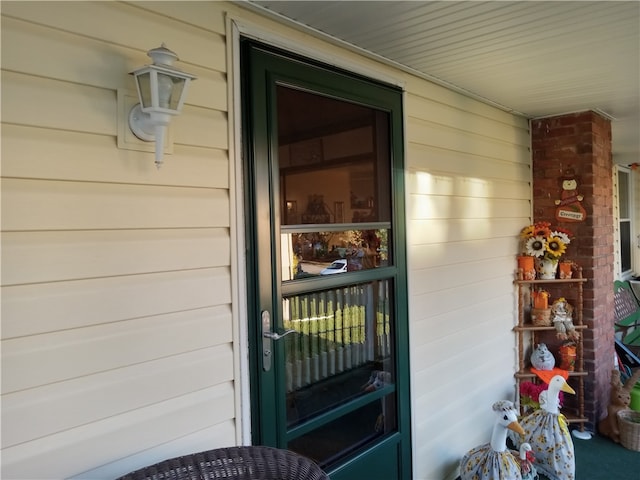 view of exterior entry with covered porch