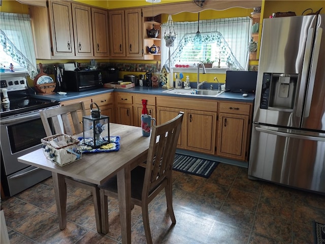 kitchen featuring appliances with stainless steel finishes, decorative backsplash, decorative light fixtures, and sink