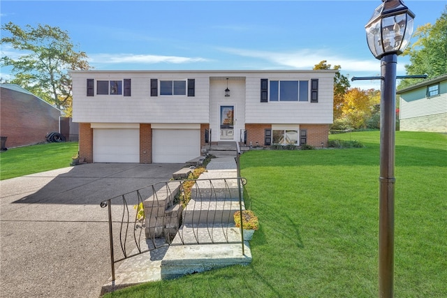 raised ranch with a front lawn and a garage