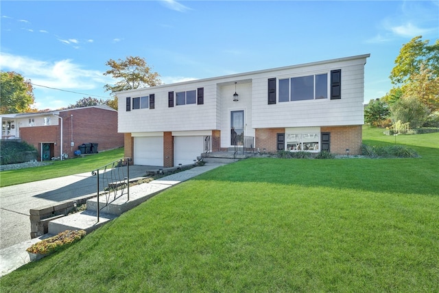 split foyer home featuring a garage and a front lawn