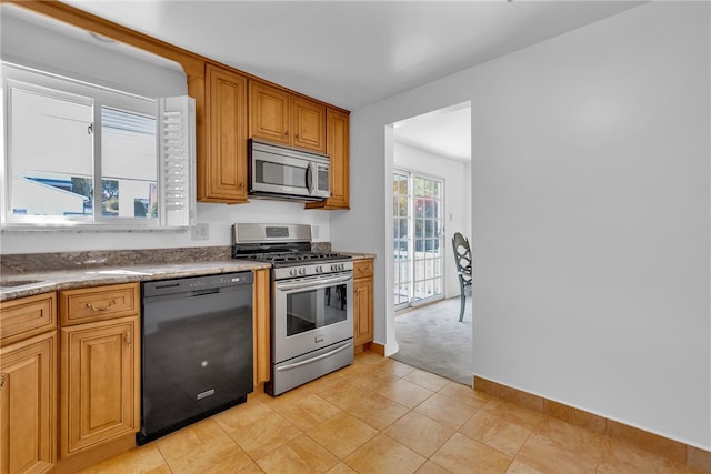 kitchen featuring appliances with stainless steel finishes and light colored carpet