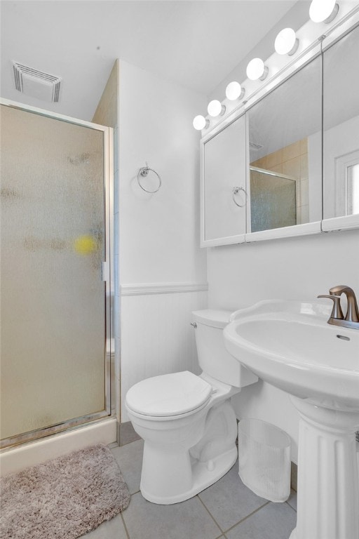 bathroom with sink, tile patterned flooring, toilet, and walk in shower