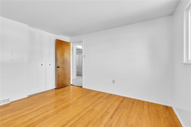 unfurnished room with light hardwood / wood-style flooring