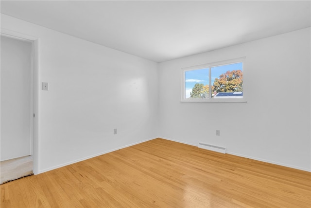 empty room with light hardwood / wood-style flooring