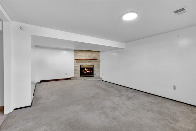 unfurnished living room with a fireplace and light colored carpet