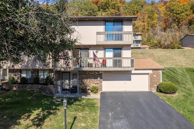 view of front of home featuring a front lawn, a garage, and a balcony