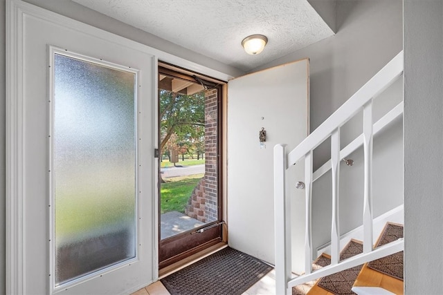 entryway featuring a textured ceiling