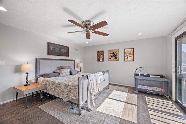 bedroom featuring dark hardwood / wood-style floors, access to exterior, a textured ceiling, and ceiling fan