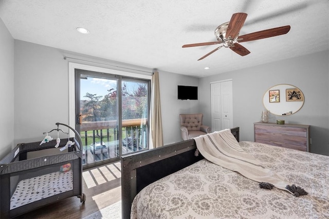 bedroom with a closet, ceiling fan, a textured ceiling, and dark hardwood / wood-style floors