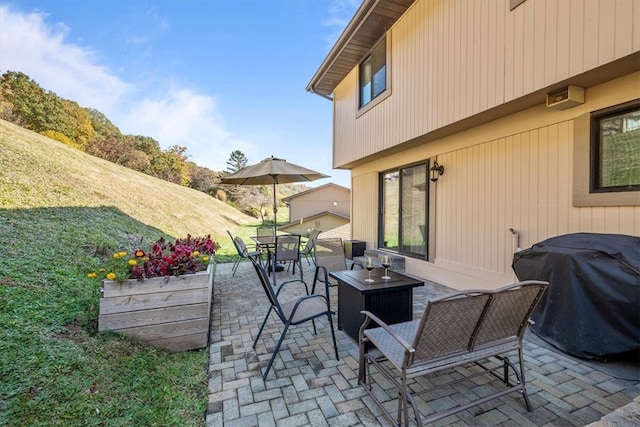 view of patio / terrace with an outdoor living space and a grill