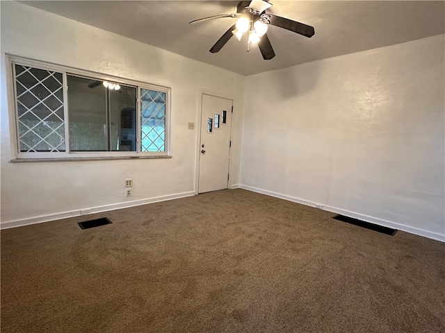 carpeted spare room with ceiling fan