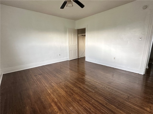 unfurnished room featuring ceiling fan and dark hardwood / wood-style floors