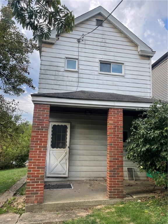 rear view of house featuring a garage