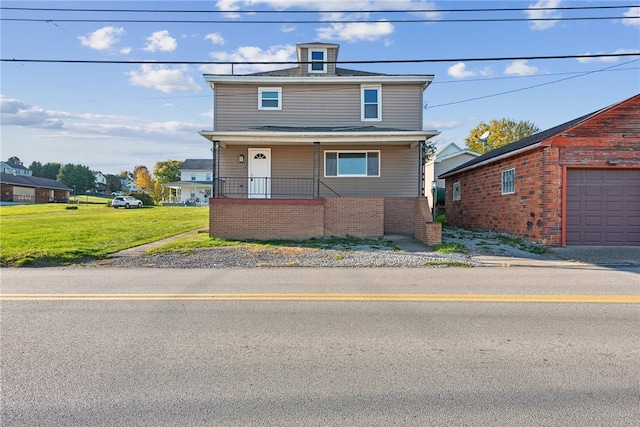 view of property featuring a front yard and a garage