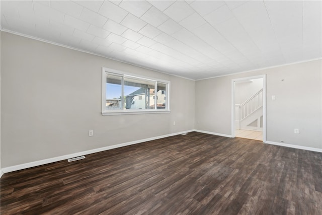 spare room featuring wood-type flooring and ornamental molding