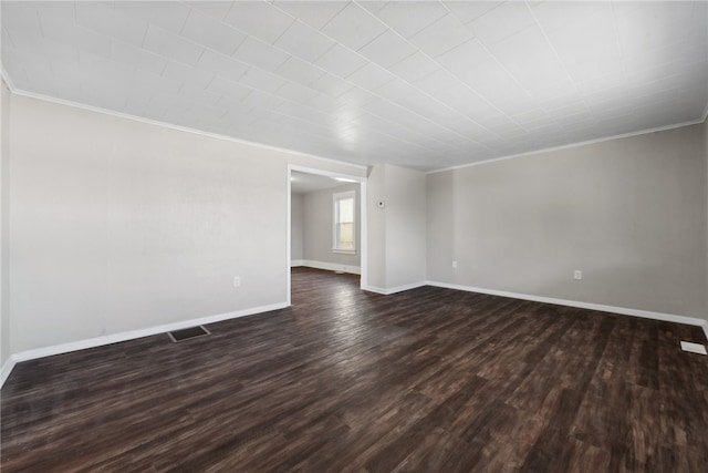 spare room with dark wood-type flooring and ornamental molding