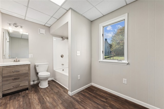 full bathroom featuring hardwood / wood-style floors, vanity, a paneled ceiling, shower / bathing tub combination, and toilet