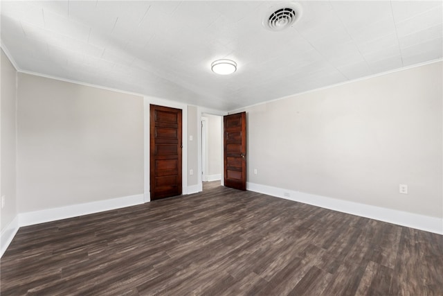 unfurnished bedroom featuring dark wood-type flooring and ornamental molding