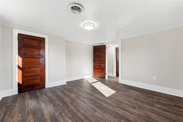 spare room featuring dark wood-type flooring