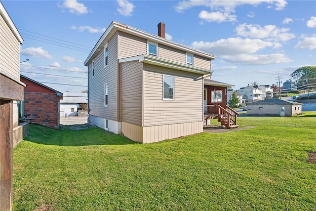 back of property featuring a lawn