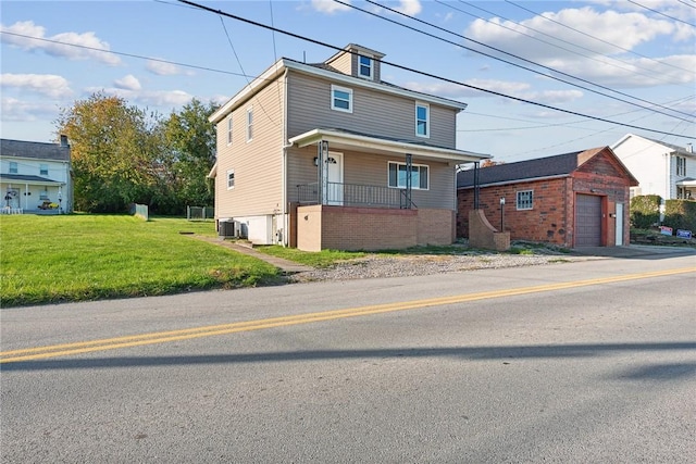 view of front of property with a front lawn, covered porch, and central AC