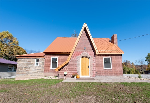 back of property with a patio and a yard