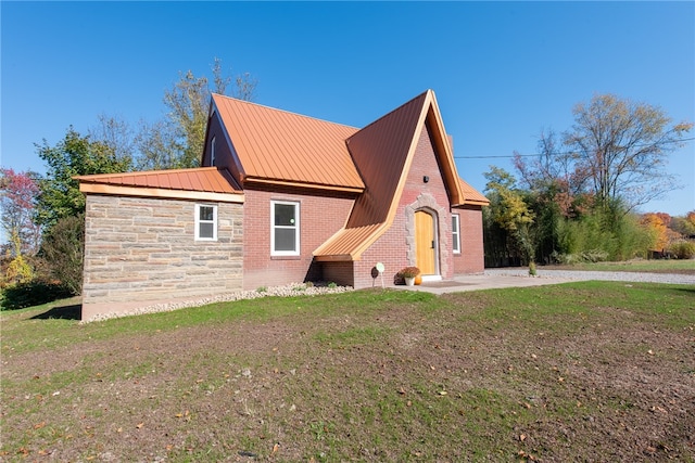 view of home's exterior with a patio and a lawn