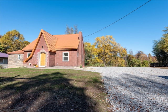 view of side of home featuring a yard