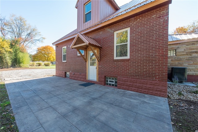 view of property exterior featuring a patio and central AC unit