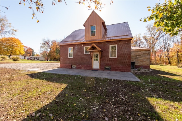 rear view of house with a patio area and a lawn