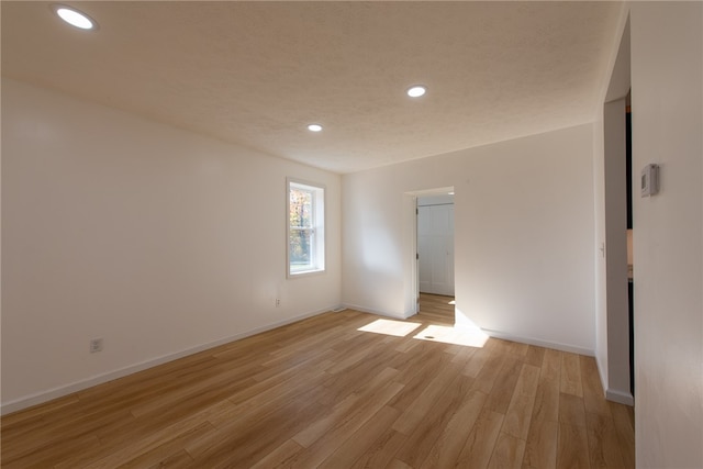 unfurnished room with light wood-type flooring