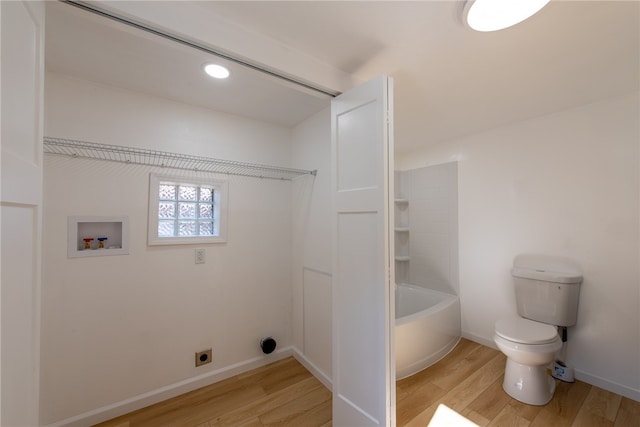 clothes washing area featuring light hardwood / wood-style flooring, hookup for a washing machine, and electric dryer hookup