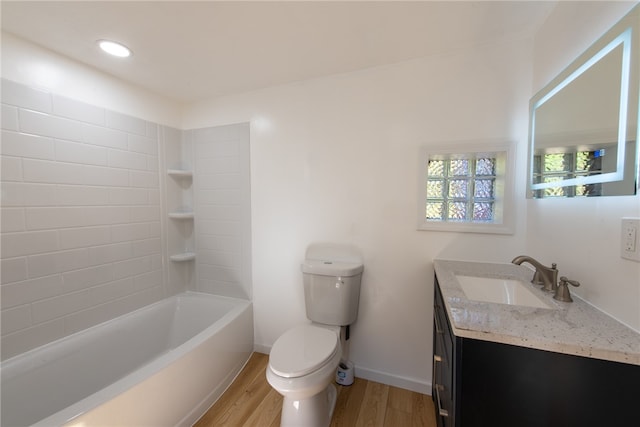 full bathroom featuring toilet, tiled shower / bath, vanity, and wood-type flooring