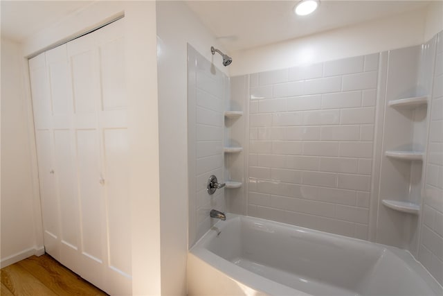 bathroom with tiled shower / bath and hardwood / wood-style flooring