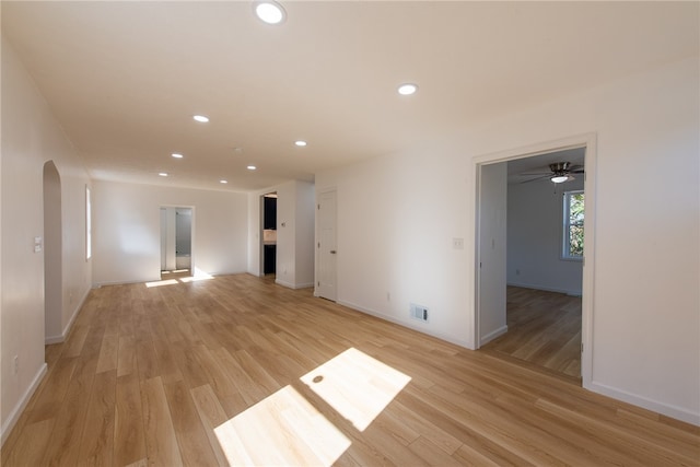 empty room featuring light wood-type flooring and ceiling fan