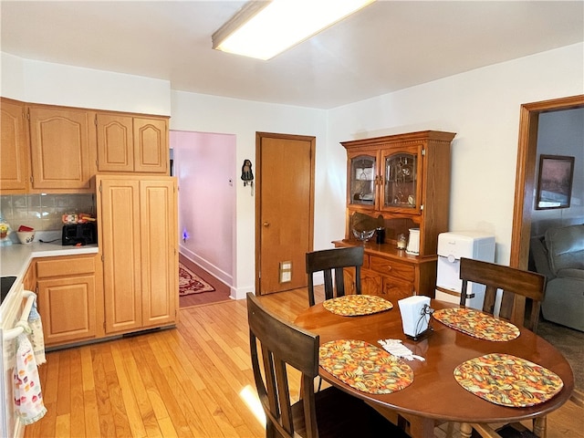 dining space with light hardwood / wood-style floors