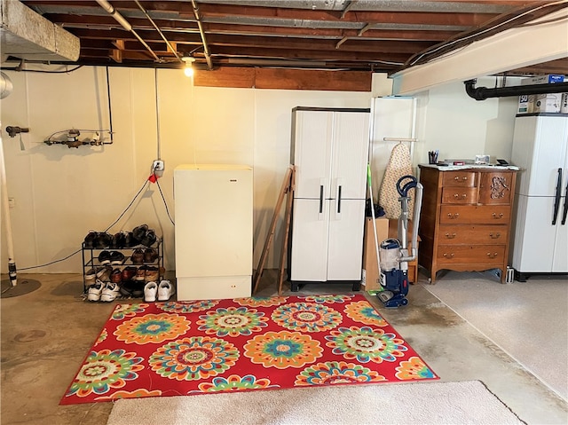 basement featuring white fridge