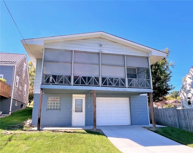 view of front of house featuring a garage and a front lawn