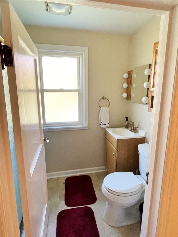 bathroom featuring toilet, vanity, and tile patterned floors